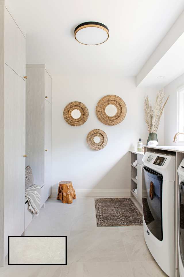 all white mudroom with hidden storage and white tile floors